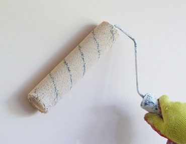Paint roller applying a new coat of paint